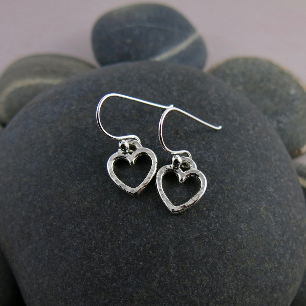 Open heart dangle earrings in sterling silver by Mikel Grant Jewellery.  Artisan made hammer textured dangles.