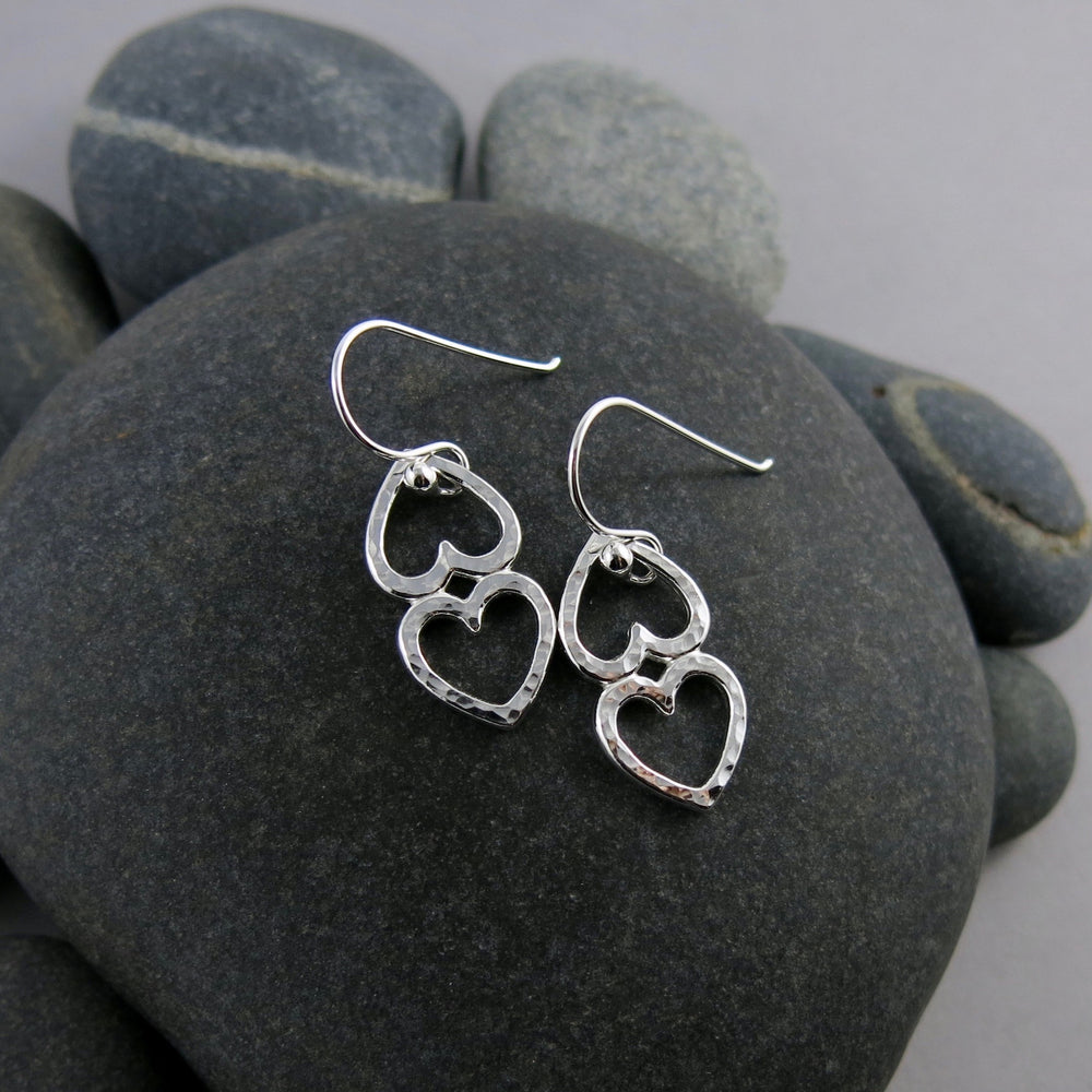 Open hearts duo earrings by Mikel Grant Jewellery. Two textured silver open hearts joined together.