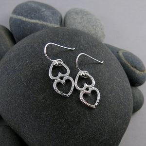 Open hearts duo earrings by Mikel Grant Jewellery. Two textured silver open hearts joined together.