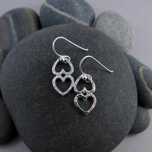 Open hearts duo earrings by Mikel Grant Jewellery. Two textured silver open hearts joined together.