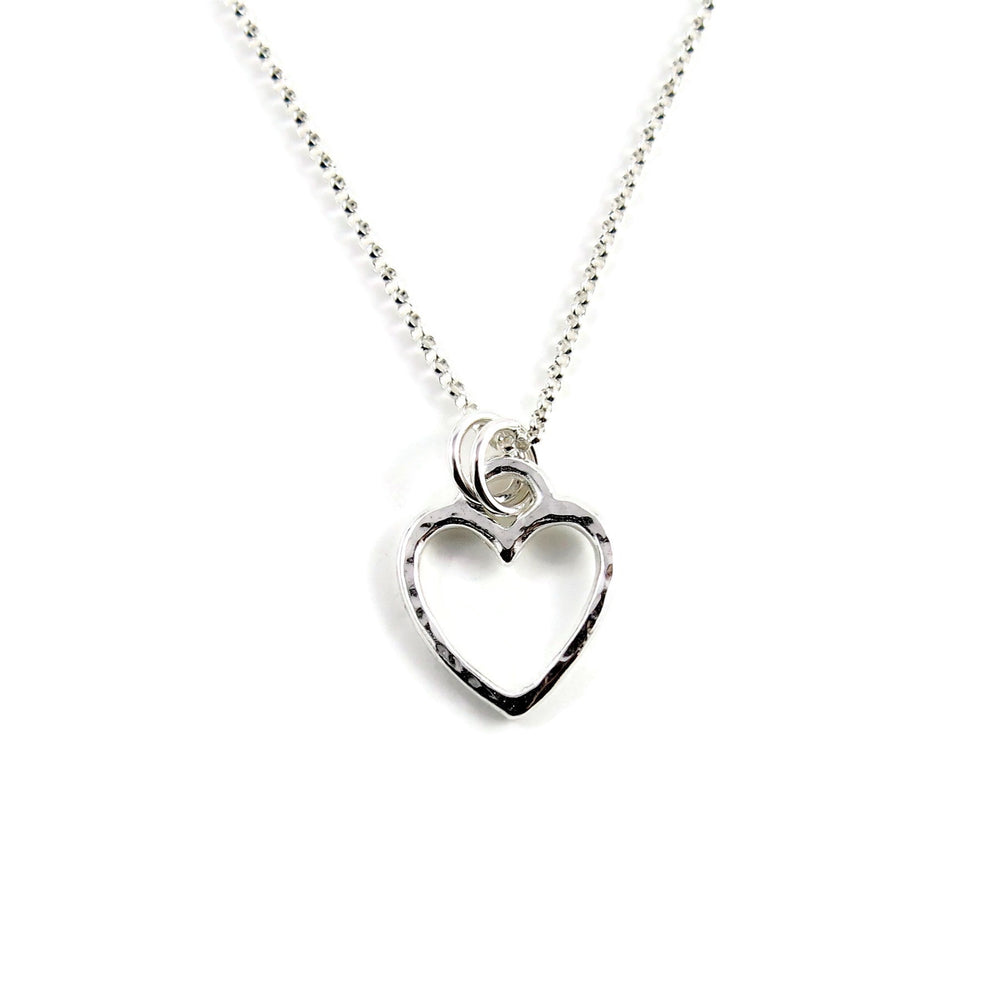 Open heart necklace in sterling silver by Mikel Grant Jewellery. Artisan made hammer textured open heart charm necklace.