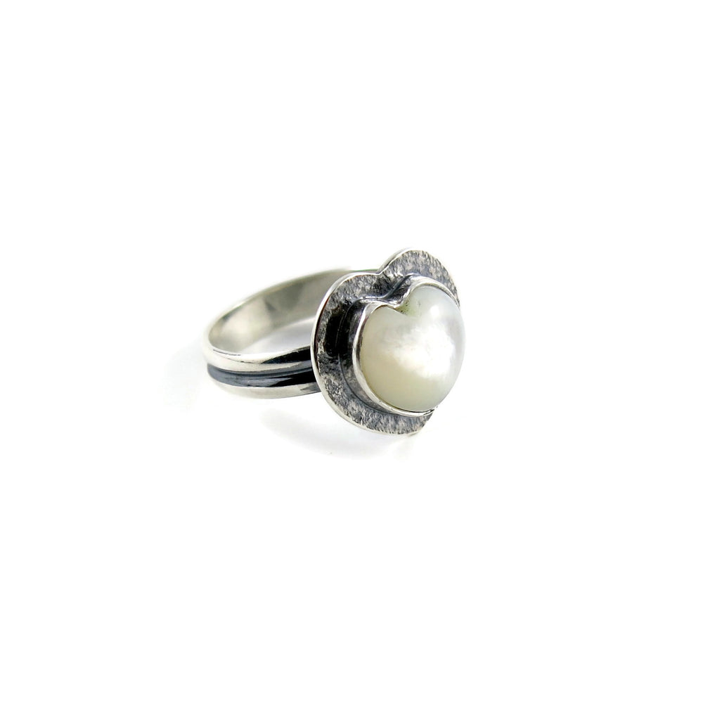 Pearl heart ring by Mikel Grant Jewellery. Hand carved mother of pearl gemstone heart in textured, oxidized sterling silver.