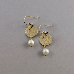Pearl moondrop earrings in gold by Mikel Grant Jewellery. White freshwater pearls suspended from hammer textured gold filled discs.