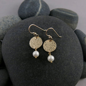 Pearl moondrop earrings in gold by Mikel Grant Jewellery. White freshwater pearls suspended from hammer textured gold filled discs.