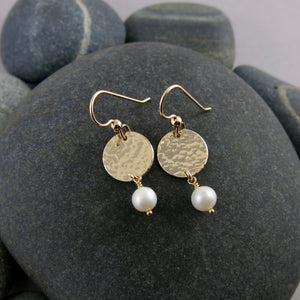 Pearl moondrop earrings in gold by Mikel Grant Jewellery. White freshwater pearls suspended from hammer textured gold filled discs.