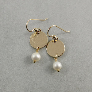 Pearl moondrop earrings in gold by Mikel Grant Jewellery. White freshwater pearls suspended from hammer textured gold filled discs.