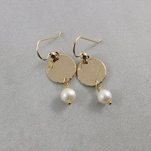 Pearl moondrop earrings in gold by Mikel Grant Jewellery. White freshwater pearls suspended from hammer textured gold filled discs.