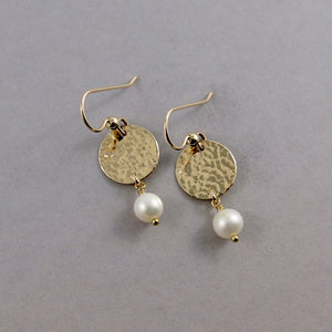 Pearl moondrop earrings in gold by Mikel Grant Jewellery. White freshwater pearls suspended from hammer textured gold filled discs.