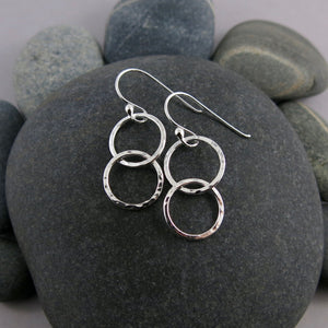 Sterling silver embrace earrings by Mikel Grant Jewellery.  Hammer textured interlocking silver ring earrings.