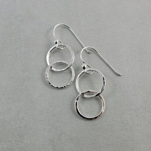 Sterling silver embrace earrings by Mikel Grant Jewellery. Hammer textured interlocking silver ring earrings.