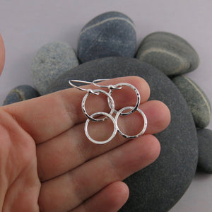 Sterling silver embrace earrings by Mikel Grant Jewellery. Hammer textured interlocking silver ring earrings.