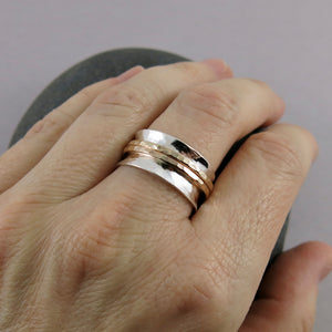 Silver hammer textured meditation ring by Mikel Grant Jewellery. Silver band with double gold spinners.