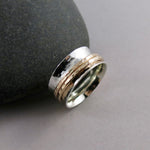 Silver hammer textured meditation ring by Mikel Grant Jewellery. Silver band with double gold spinners.