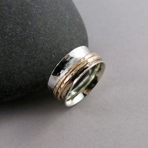 Silver hammer textured meditation ring by Mikel Grant Jewellery. Silver band with double gold spinners.