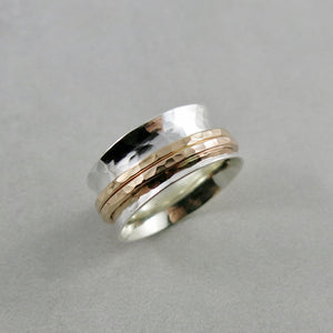 Silver hammer textured meditation ring by Mikel Grant Jewellery. Silver band with double gold spinners.