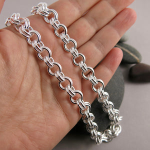 Artisan made heavy silver double chain link necklace by Mikel Grant Jewellery. Displayed on a hand.