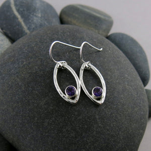 Minimalist sterling silver leaf earrings with faceted amethyst gemstones by Mikel Grant Jewellery.