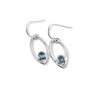 Minimalist sterling silver leaf earrings with faceted blue topaz gemstones by Mikel Grant Jewellery.