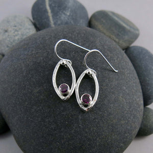 Minimalist sterling silver leaf earrings with faceted garnet gemstones by Mikel Grant Jewellery.