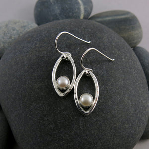 Silver leaf earrings with white button pearls by Mikel Grant Jewellery. Modern minimalist nature inspired earrings