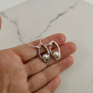 Silver leaf earrings with white button pearls by Mikel Grant Jewellery. Modern minimalist nature inspired earrings