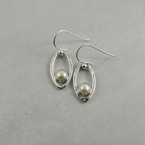 Silver leaf earrings with white button pearls by Mikel Grant Jewellery. Modern minimalist nature inspired earrings