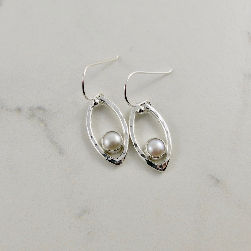 Silver leaf earrings with white button pearls by Mikel Grant Jewellery.  Modern minimalist nature inspired earrings