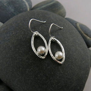 Silver leaf earrings with white button pearls by Mikel Grant Jewellery. Modern minimalist nature inspired earrings