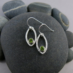 Minimalist sterling silver leaf earrings with faceted peridot gemstones by Mikel Grant Jewellery.