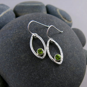 Minimalist sterling silver leaf earrings with faceted peridot gemstones by Mikel Grant Jewellery.