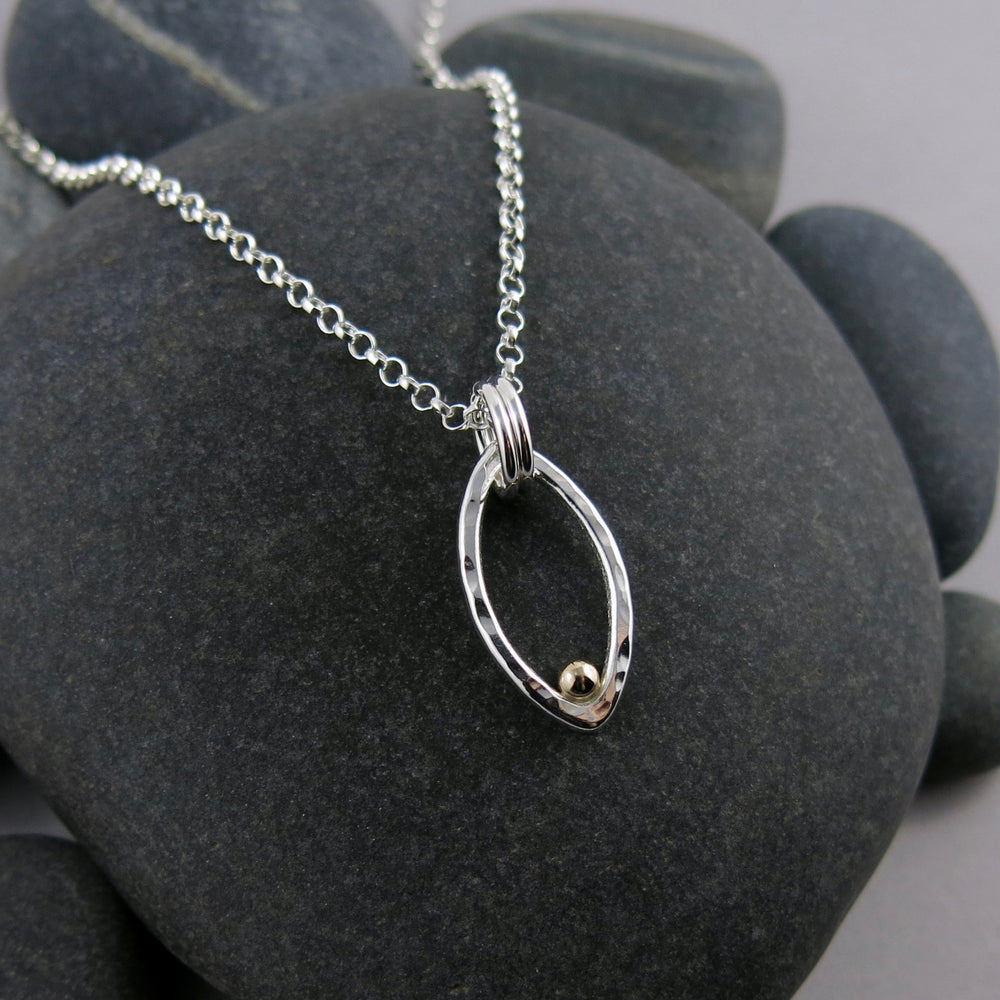 Modern minimalist sterling silver leaf necklace with gold dewdrop by Mikel Grant Jewellery.