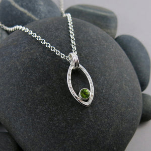 Modern minimalist sterling silver leaf necklace with faceted peridot gemstone by Mikel Grant Jewellery.