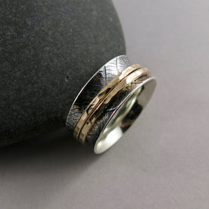 Leaf print meditation ring in silver and gold by Mikel Grant Jewellery. Double gold spinning bands on a silver leaf print ring.