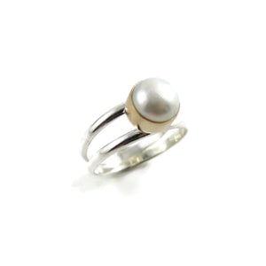 Silver and Gold Split Shank Pearl Ring by Mikel Grant Jewellery. White freshwater button pearl bezel set in 14K gold on a sterling silver split shank band.