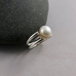 Silver and Gold Split Shank Pearl Ring by Mikel Grant Jewellery. White freshwater button pearl bezel set in 14K gold on a sterling silver split shank band.