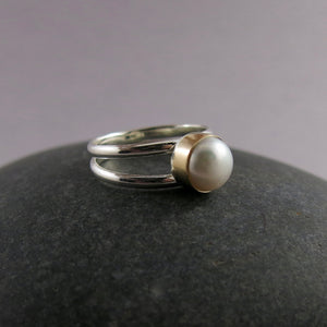 Silver and Gold Split Shank Pearl Ring by Mikel Grant Jewellery. White freshwater button pearl bezel set in 14K gold on a sterling silver split shank band.