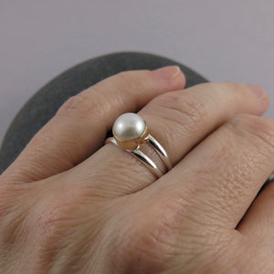 Silver and Gold Split Shank Pearl Ring by Mikel Grant Jewellery. White freshwater button pearl bezel set in 14K gold on a sterling silver split shank band.