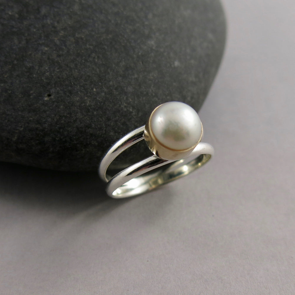 Silver and Gold Split Shank Pearl Ring by Mikel Grant Jewellery.  White freshwater button pearl bezel set in 14K gold on a sterling silver split shank band.
