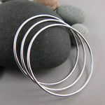 Artisan made thick smooth sterling silver bangle by Mikel Grant Jewellery.