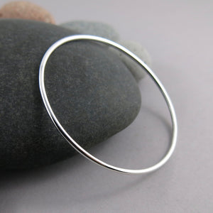 Artisan made thick smooth sterling silver bangle by Mikel Grant Jewellery.