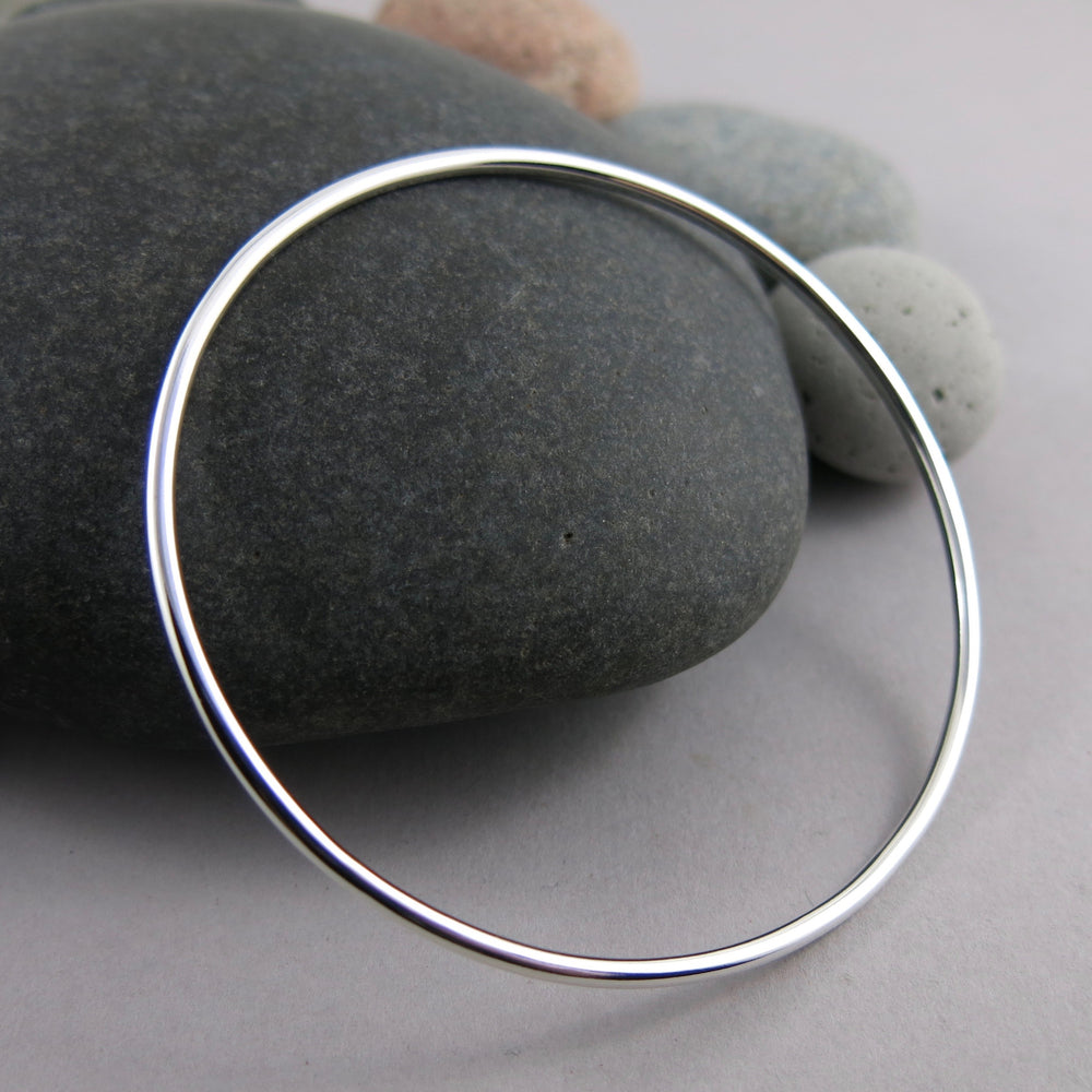 Artisan made thick smooth sterling silver bangle by Mikel Grant Jewellery.