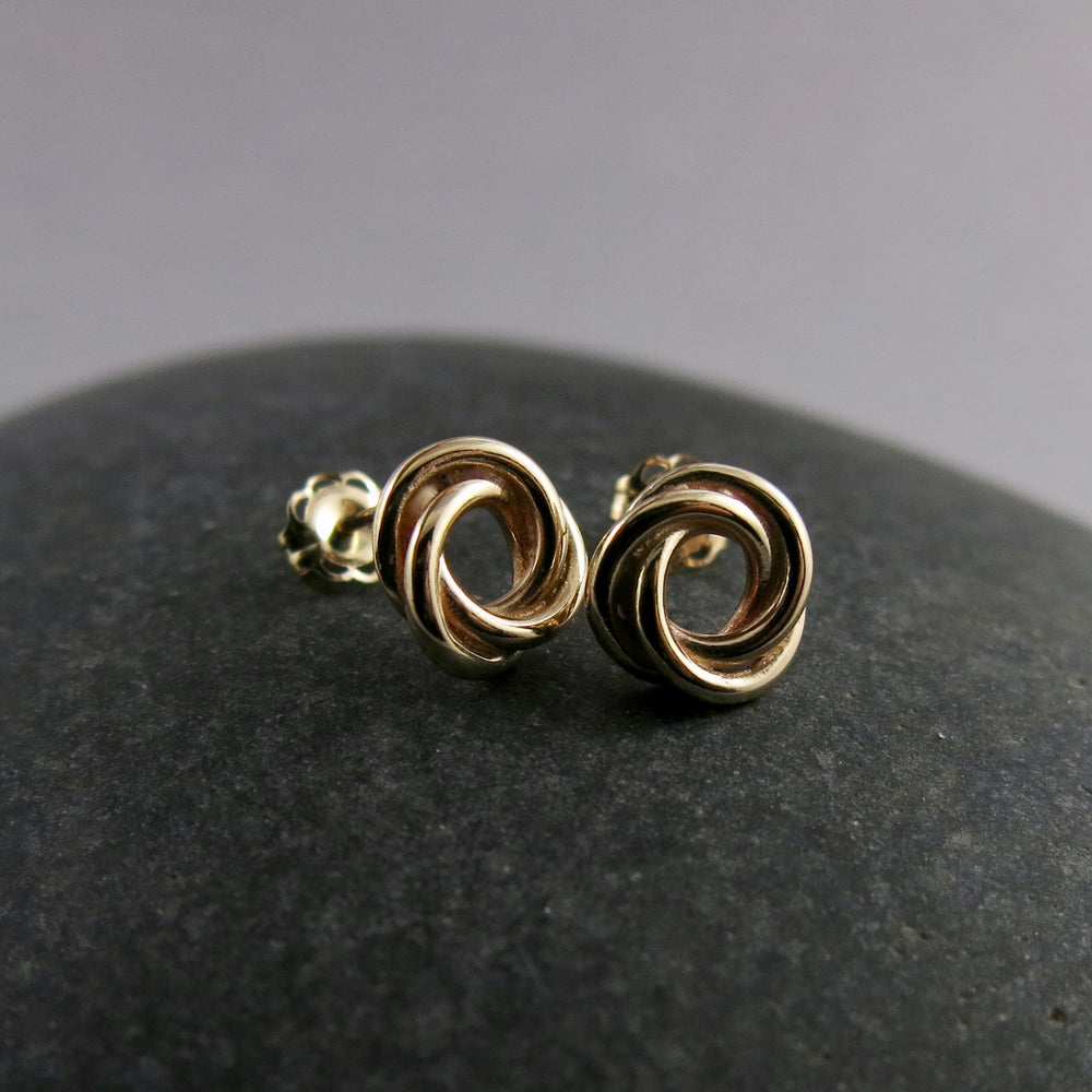 Gold love knot trio studs by Mikel Grant Jewellery.