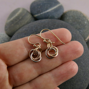 Solid gold mixed metal love knot earrings by Mikel Grant Jewellery. Artisan made infinite knot earrings in 14K yellow, rose and palladium white gold.