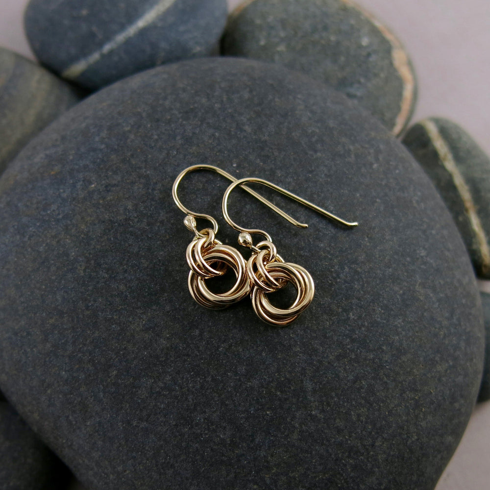 Solid gold love knot earrings by Mikel Grant Jewellery. Artisan made moveable infinite knot earrings.