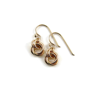 Solid gold love knot earrings by Mikel Grant Jewellery. Artisan made moveable infinite knot earrings.