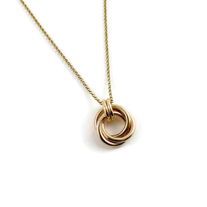 Solid gold love knot trinity necklace by Mikel Grant Jewellery. Artisan made solid gold infinite knot necklace.
