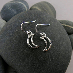 Handcrafted sterling silver hammer textured crescent moon dangle earrings by MIkel Grant Jewellery.