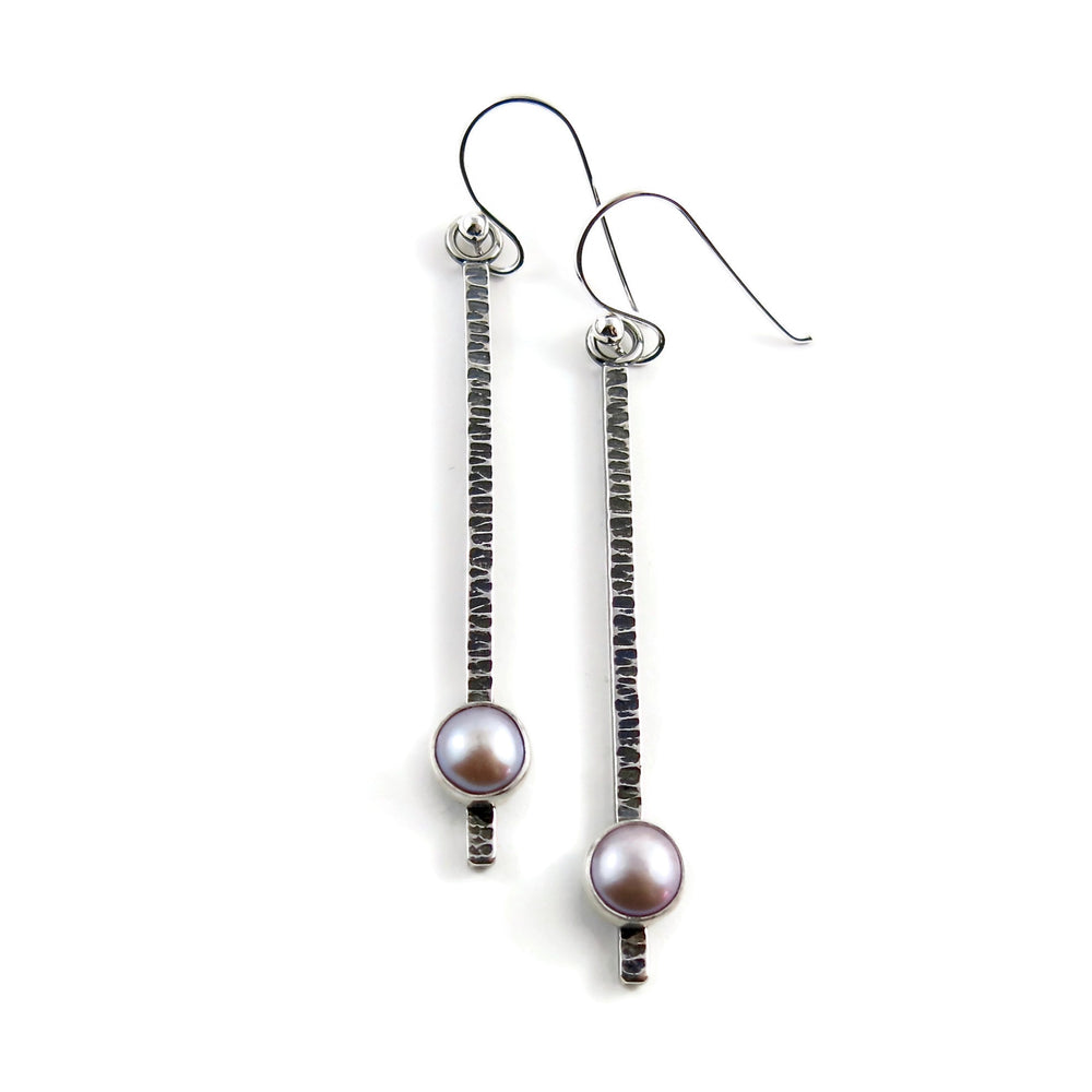 Pearl pendulum earrings by Mikel Grant Jewellery. Pink freshwater pearls on textured and oxidized sterling silver bars.