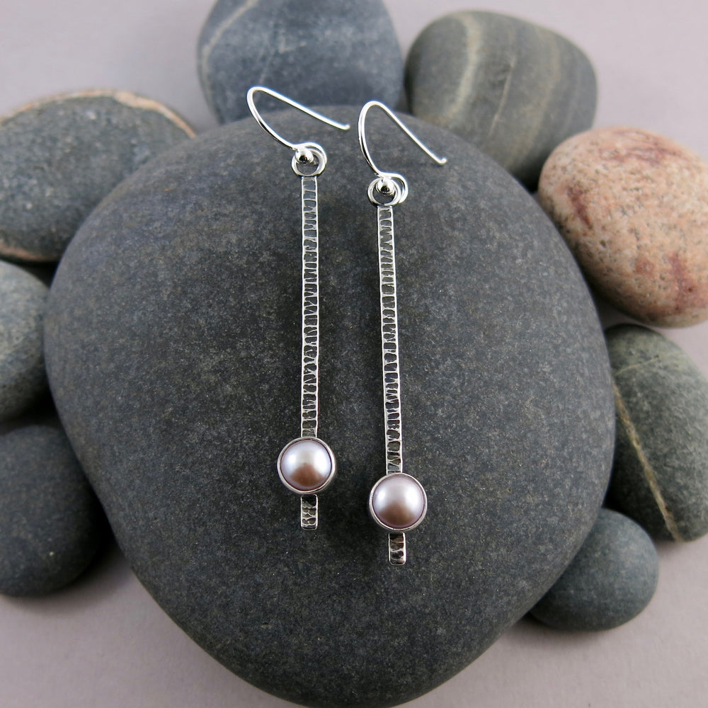 Pearl pendulum earrings by Mikel Grant Jewellery.   Pink freshwater pearls on textured and oxidized sterling silver bars.