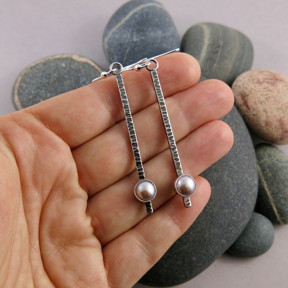 Pearl pendulum earrings by Mikel Grant Jewellery. Pink freshwater pearls on textured and oxidized sterling silver bars.